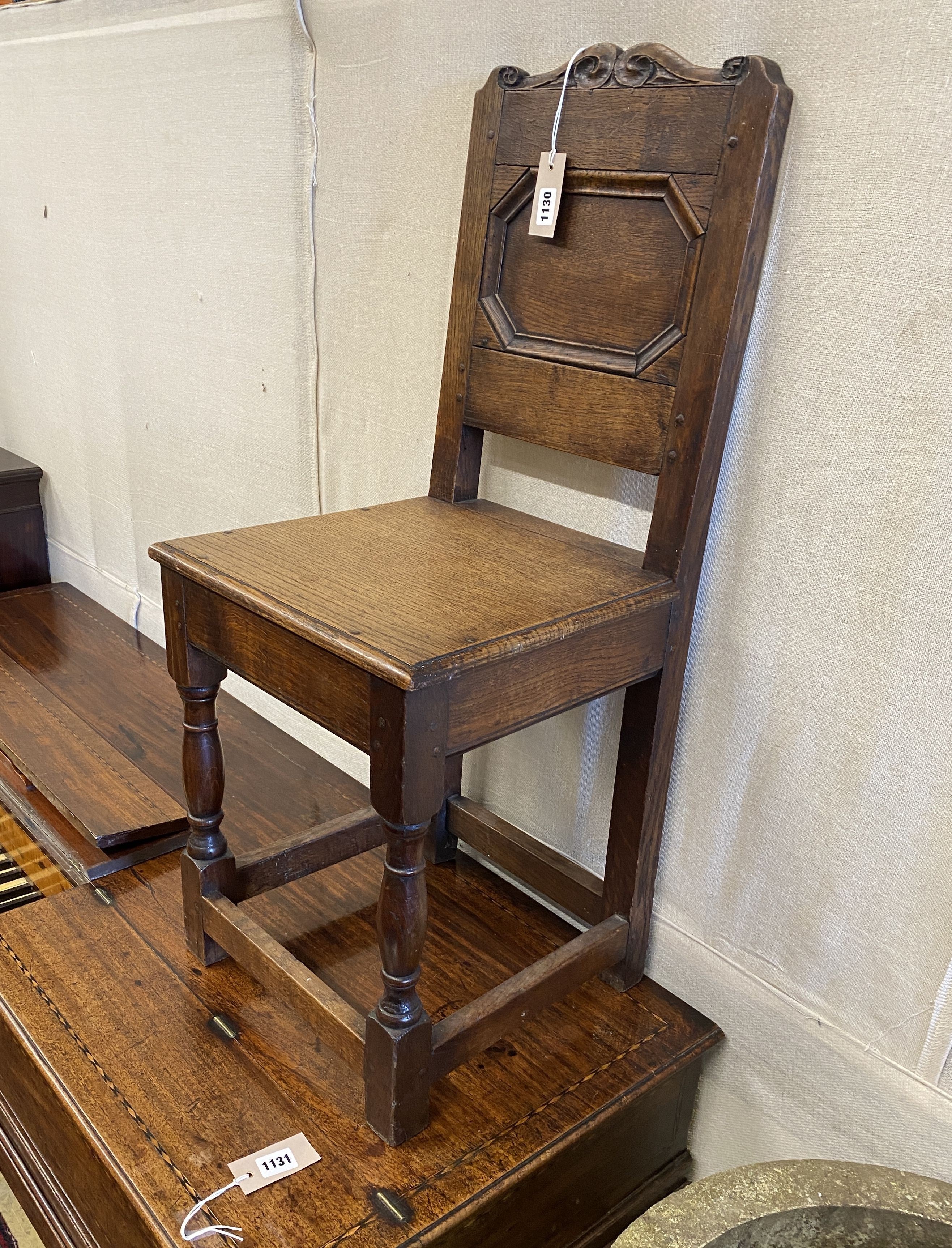 An 18th century and later oak back stool